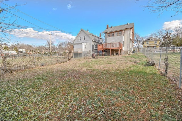 back of property featuring a lawn and a deck