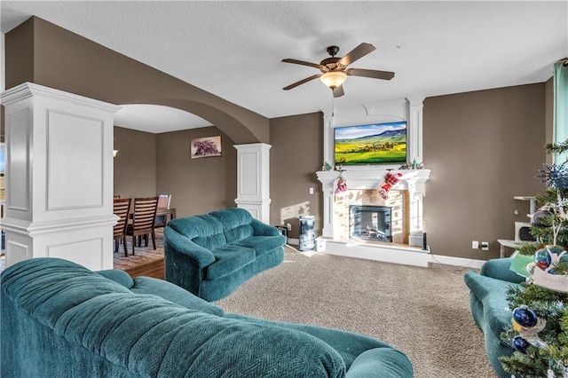 living room with carpet floors, ornate columns, and ceiling fan