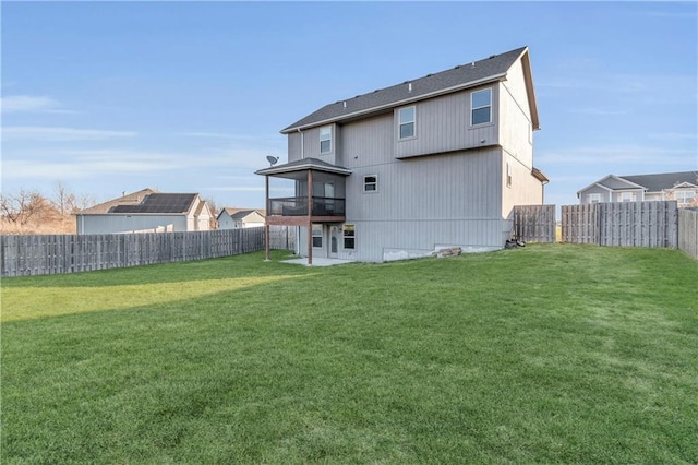 back of property featuring a sunroom and a yard