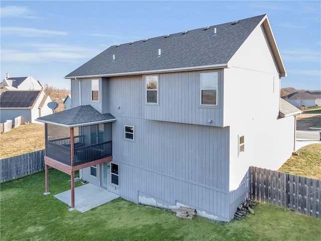 rear view of house with a patio area, a sunroom, and a yard