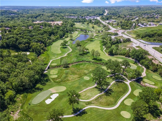 birds eye view of property featuring golf course view, a view of trees, and a water view