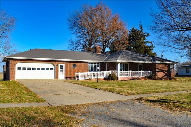 ranch-style house featuring a front yard, a porch, and a garage