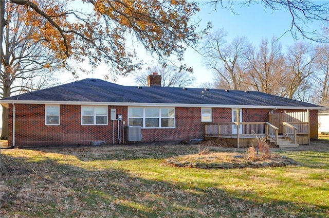 back of property with central air condition unit, a lawn, and a wooden deck