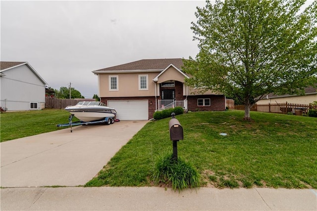 1702 Arrowhead Dr, Atchison, KS 66002 - bi-level home with brick siding, an attached garage, driveway, and stucco siding