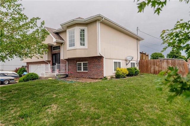 1702 Arrowhead Dr, Atchison, KS 66002 - view of front of home with brick siding, stucco siding, and a garage