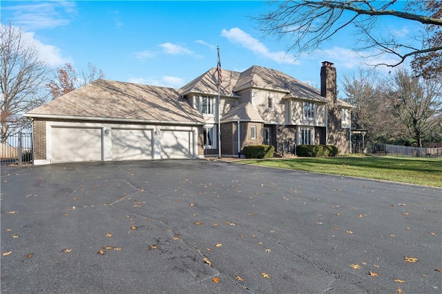 view of front facade with a front yard and a garage