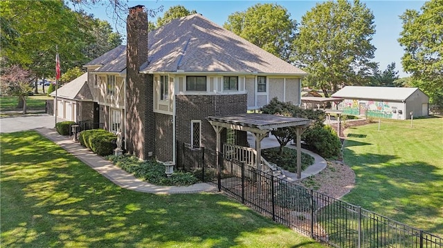 back of house featuring a pergola, a lawn, and a garage