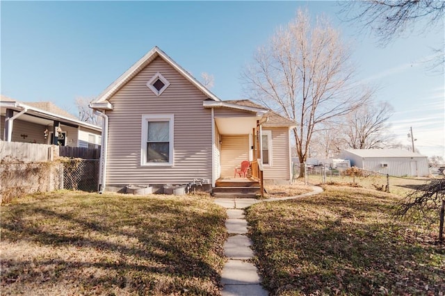 bungalow-style home with a front lawn