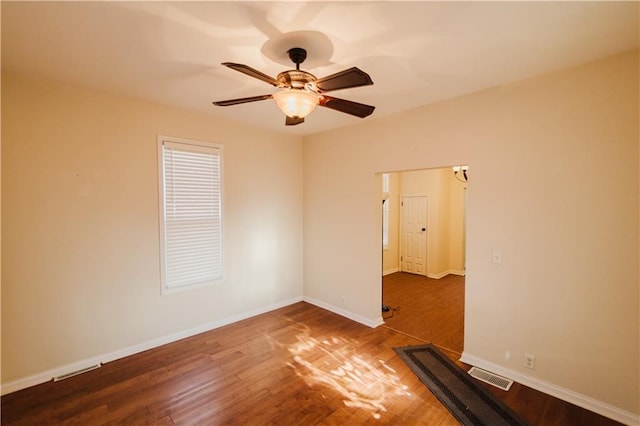 spare room featuring wood-type flooring and ceiling fan