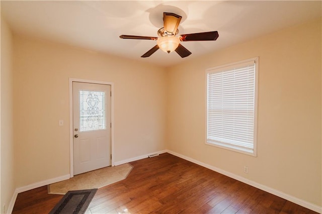 spare room with wood-type flooring and ceiling fan