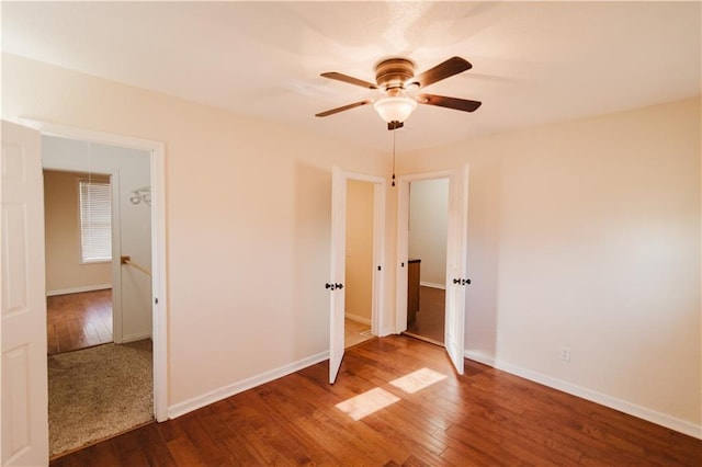 unfurnished bedroom with ceiling fan and wood-type flooring