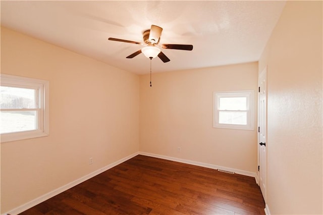 unfurnished room with ceiling fan, dark hardwood / wood-style flooring, and a wealth of natural light