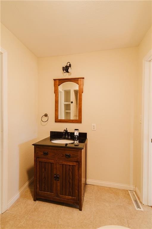 bathroom featuring tile patterned flooring and vanity