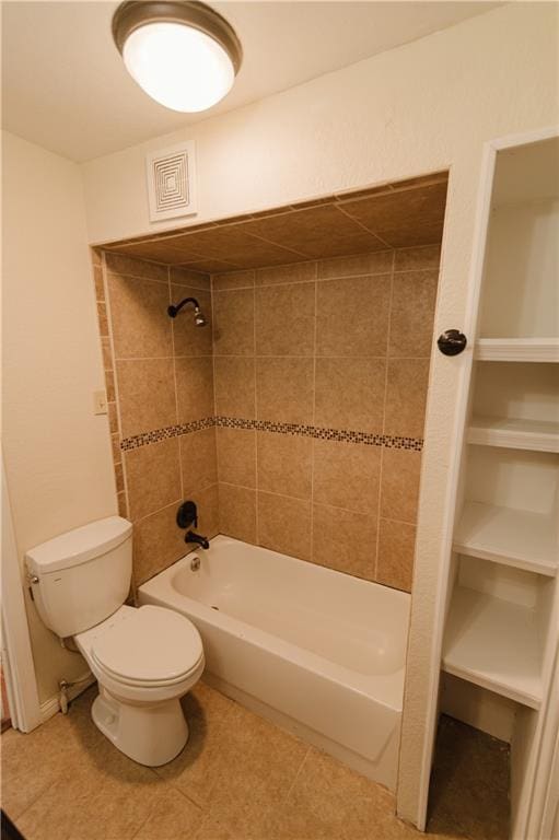 bathroom with tiled shower / bath combo and toilet