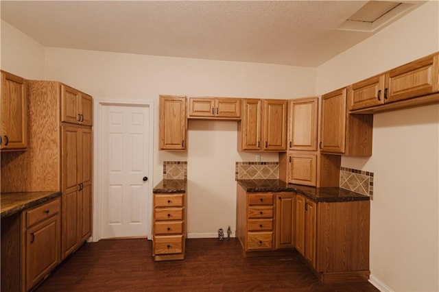 kitchen featuring dark hardwood / wood-style flooring and dark stone counters