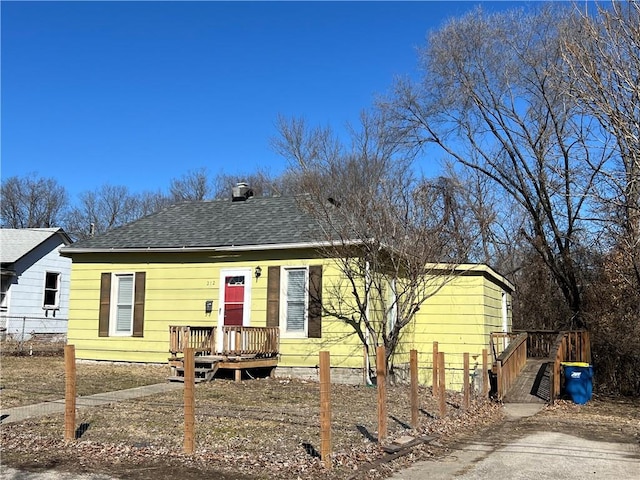 bungalow-style house with fence and roof with shingles