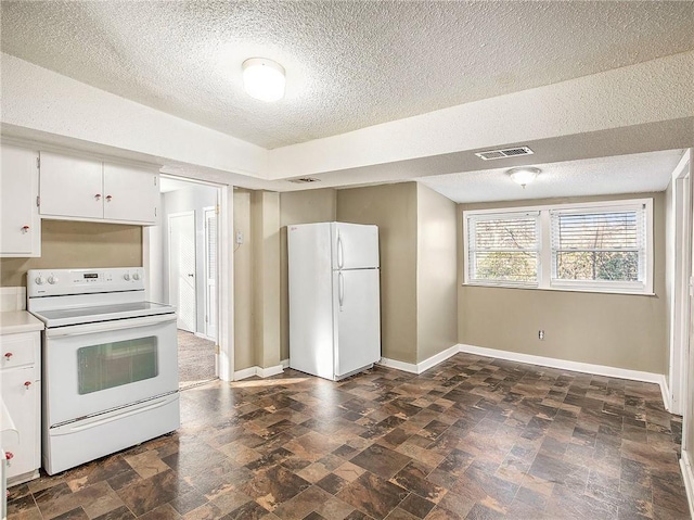 kitchen with white appliances, baseboards, visible vents, and stone finish flooring