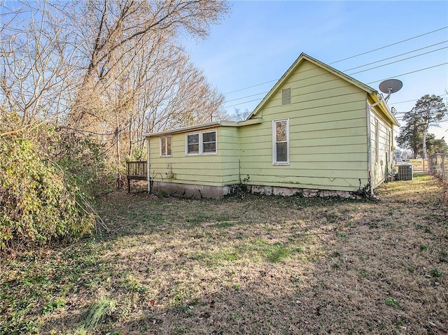 rear view of property with central AC unit