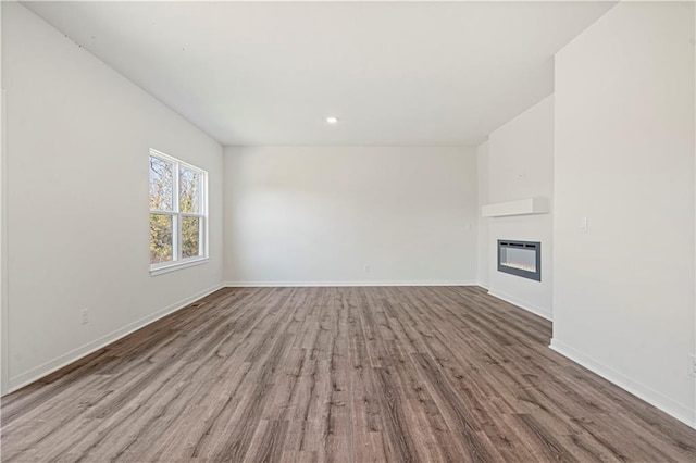 unfurnished living room with light hardwood / wood-style floors and heating unit