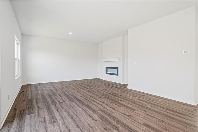 unfurnished living room with hardwood / wood-style flooring