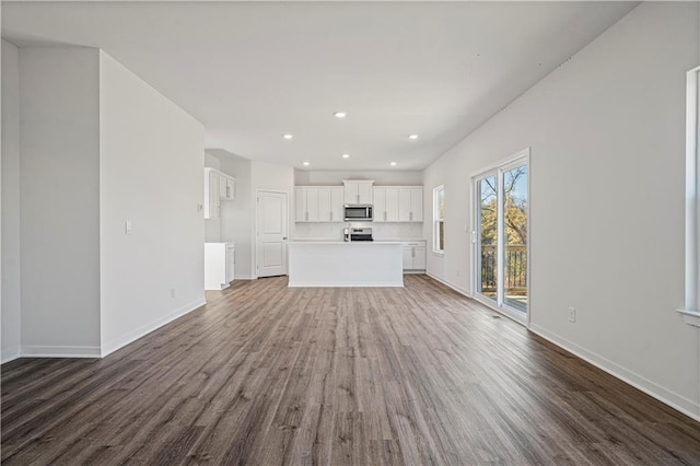 unfurnished living room with dark wood-type flooring