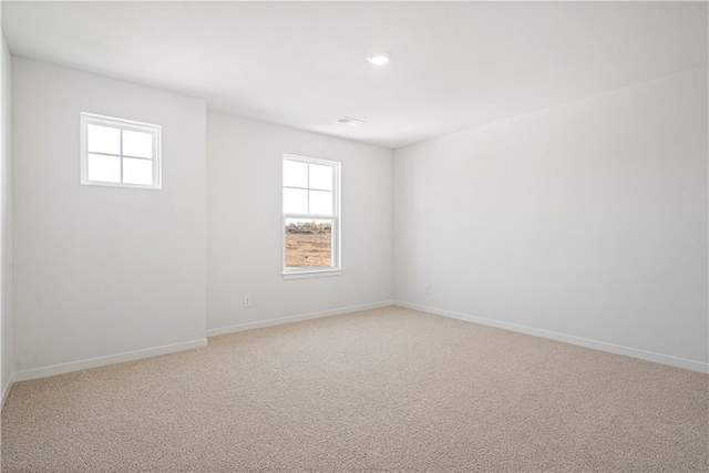 carpeted empty room with a wealth of natural light