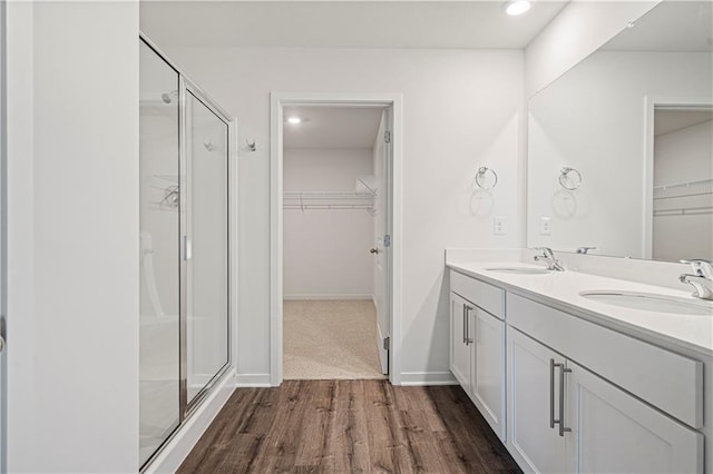 bathroom featuring vanity, hardwood / wood-style flooring, and an enclosed shower