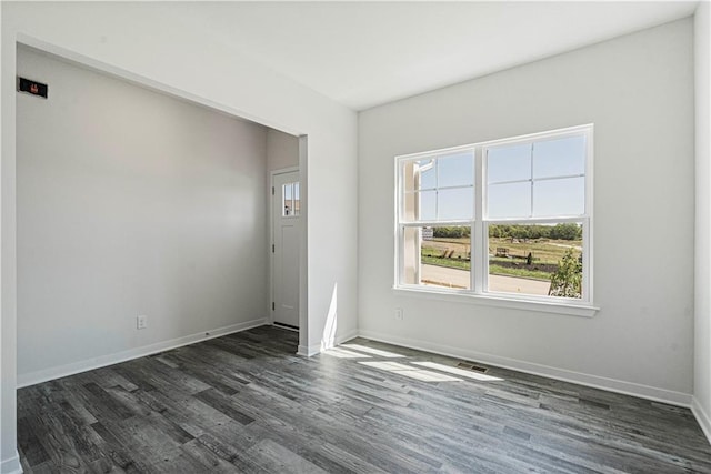 21805 Vinci Cir, Peculiar, MO 64078 - spare room with dark wood-style flooring and baseboards