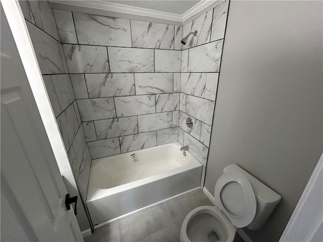 bathroom with toilet, tiled shower / bath, and crown molding