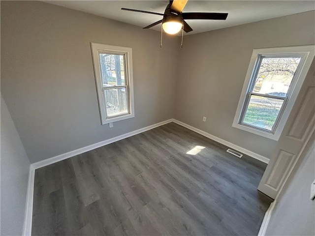 unfurnished room featuring ceiling fan and dark wood-type flooring