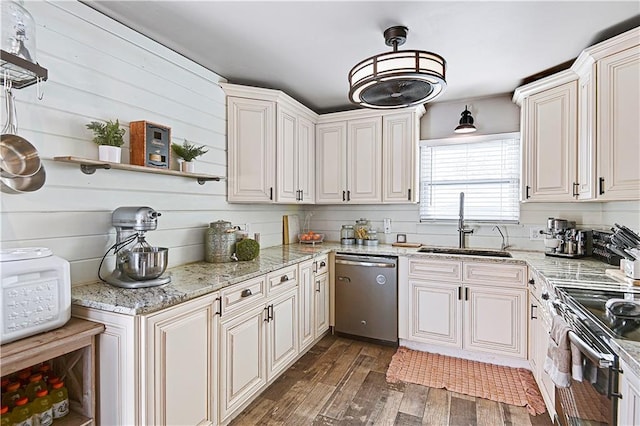 kitchen with appliances with stainless steel finishes, light stone counters, dark wood-type flooring, sink, and white cabinets