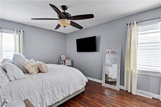 bedroom with ceiling fan and dark hardwood / wood-style flooring