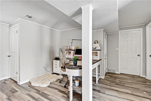 office space with a textured ceiling, light hardwood / wood-style floors, and ornamental molding