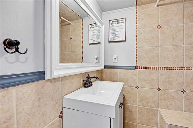 bathroom with crown molding, vanity, tile walls, and walk in shower