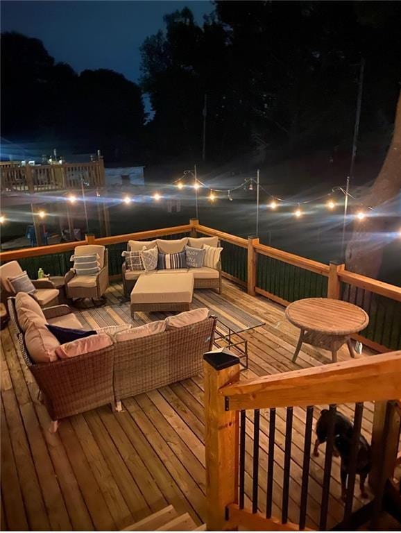 deck at twilight with an outdoor hangout area