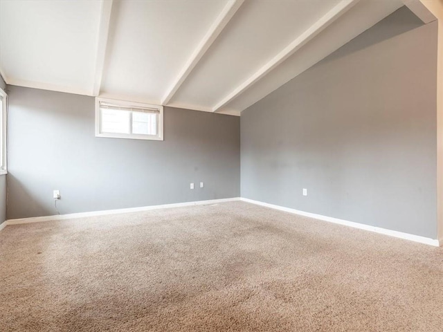 carpeted spare room featuring lofted ceiling with beams