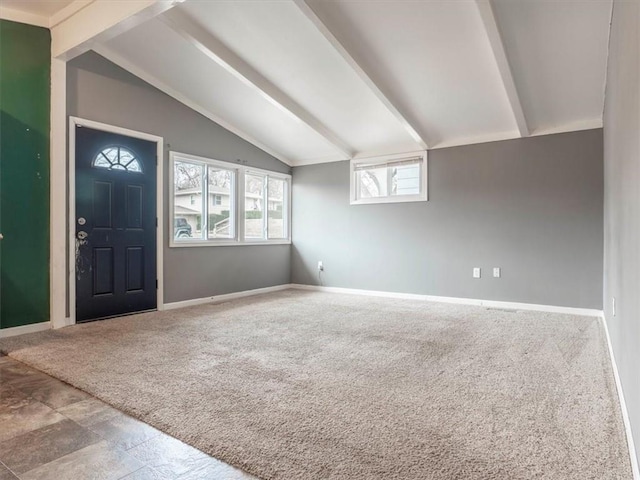 carpeted foyer entrance with lofted ceiling with beams