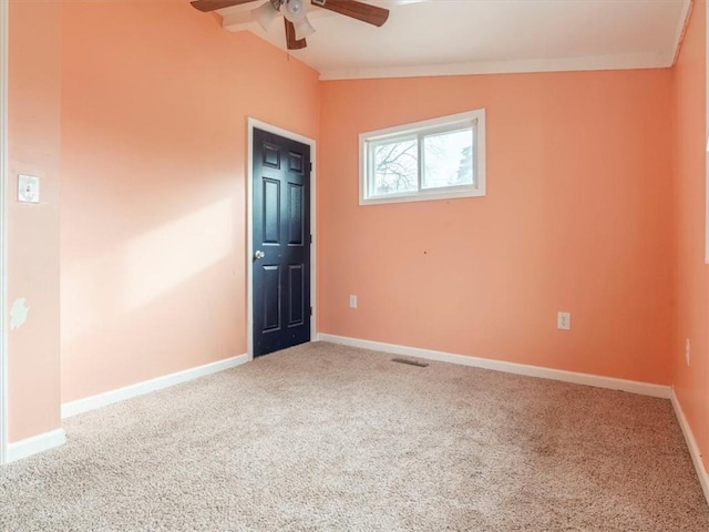 carpeted spare room featuring ceiling fan and lofted ceiling