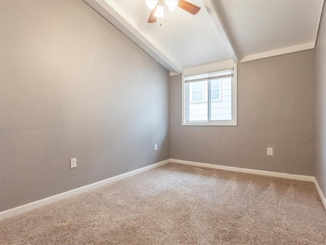 empty room with carpet flooring, ceiling fan, and lofted ceiling with beams