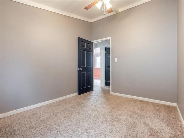 spare room with carpet flooring, ceiling fan, and crown molding