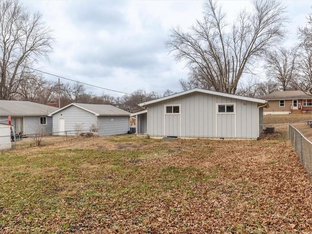 back of property with a lawn