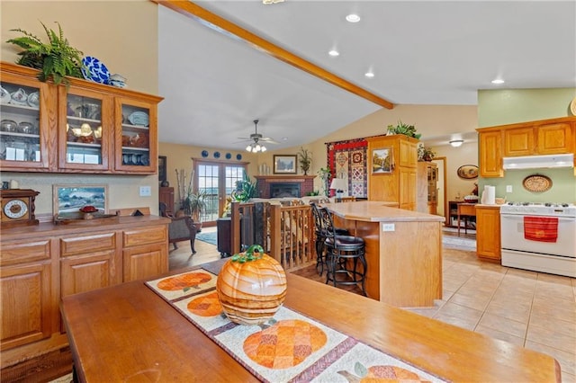 tiled dining room featuring vaulted ceiling with beams and ceiling fan