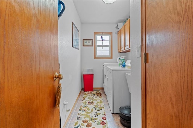 laundry room featuring light tile patterned floors, cabinets, and independent washer and dryer