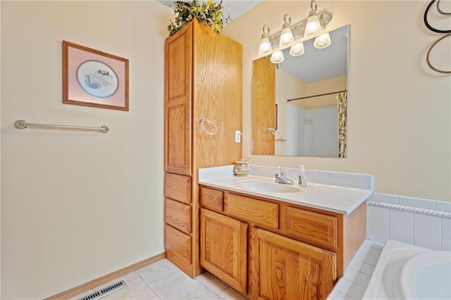 bathroom featuring plus walk in shower, vanity, and tile patterned floors