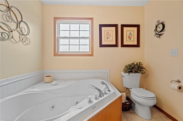 bathroom featuring tile patterned flooring, a relaxing tiled tub, and toilet