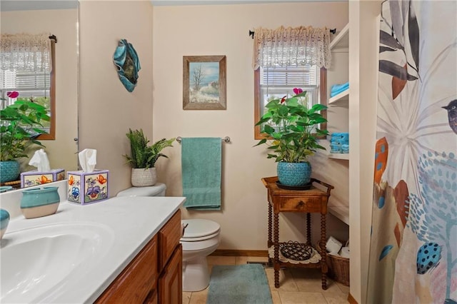 bathroom featuring tile patterned floors, vanity, and toilet