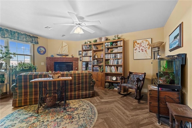 living room featuring a fireplace, parquet floors, and ceiling fan