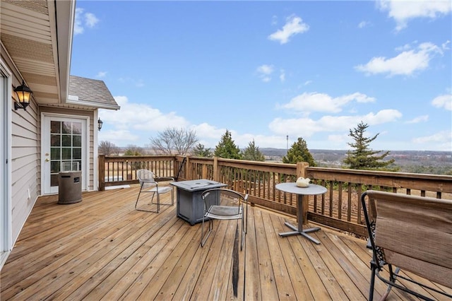 wooden terrace featuring a fire pit