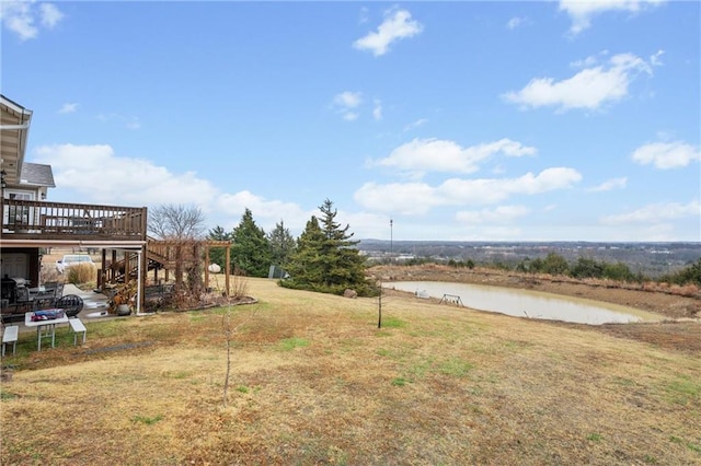 view of yard featuring a deck with water view