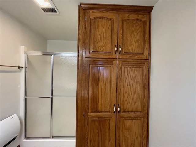 bathroom with a shower with shower door